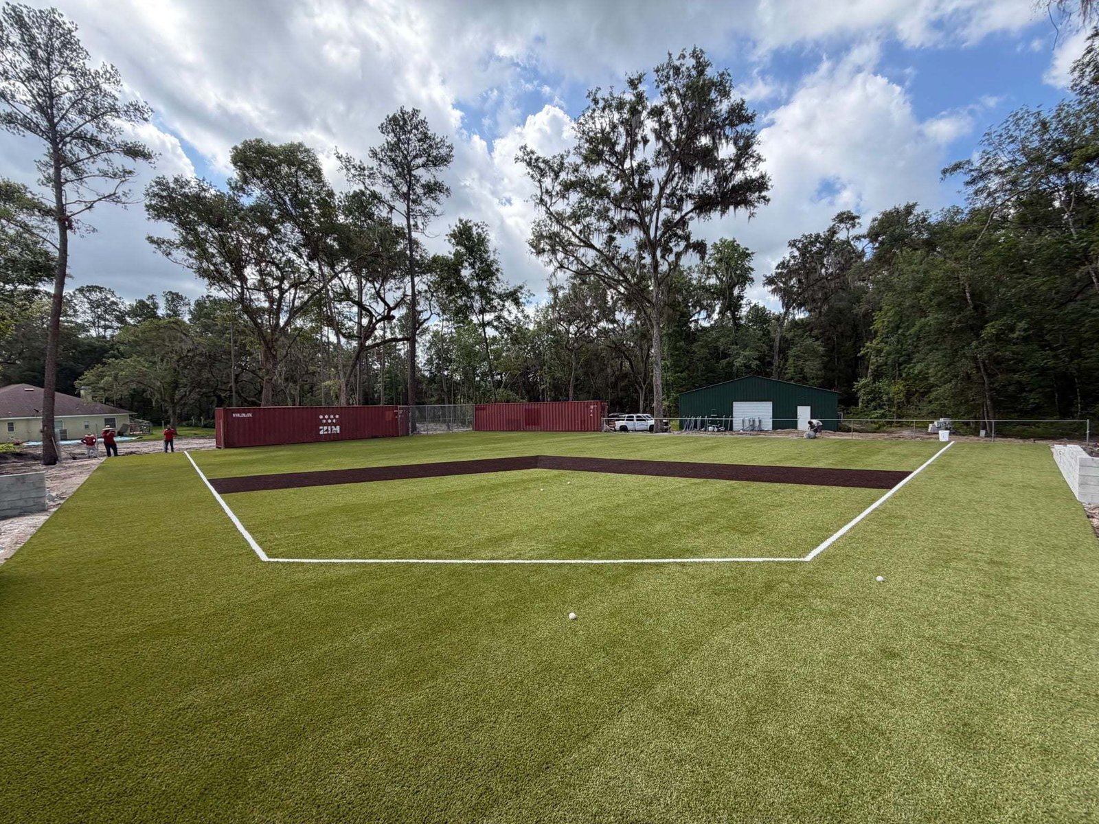 Baseball training field of artificial turf with the infield lined in white, installed by ProTurf Solutions