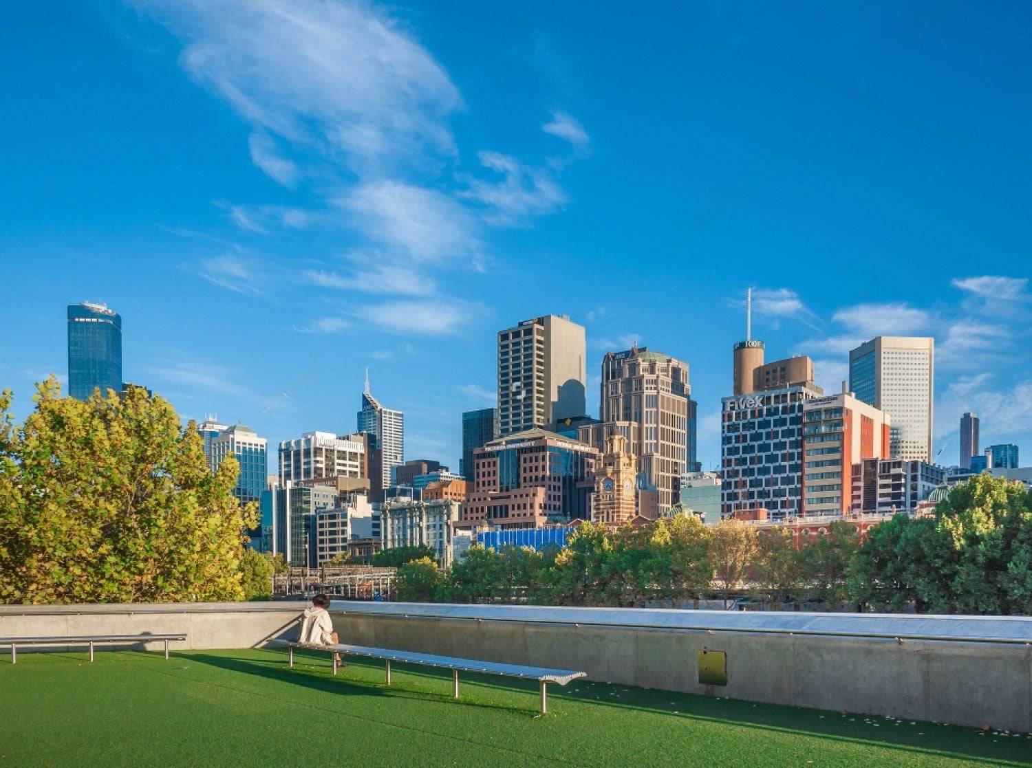 Rooftop artificial turf lawn with a city skyline behind it