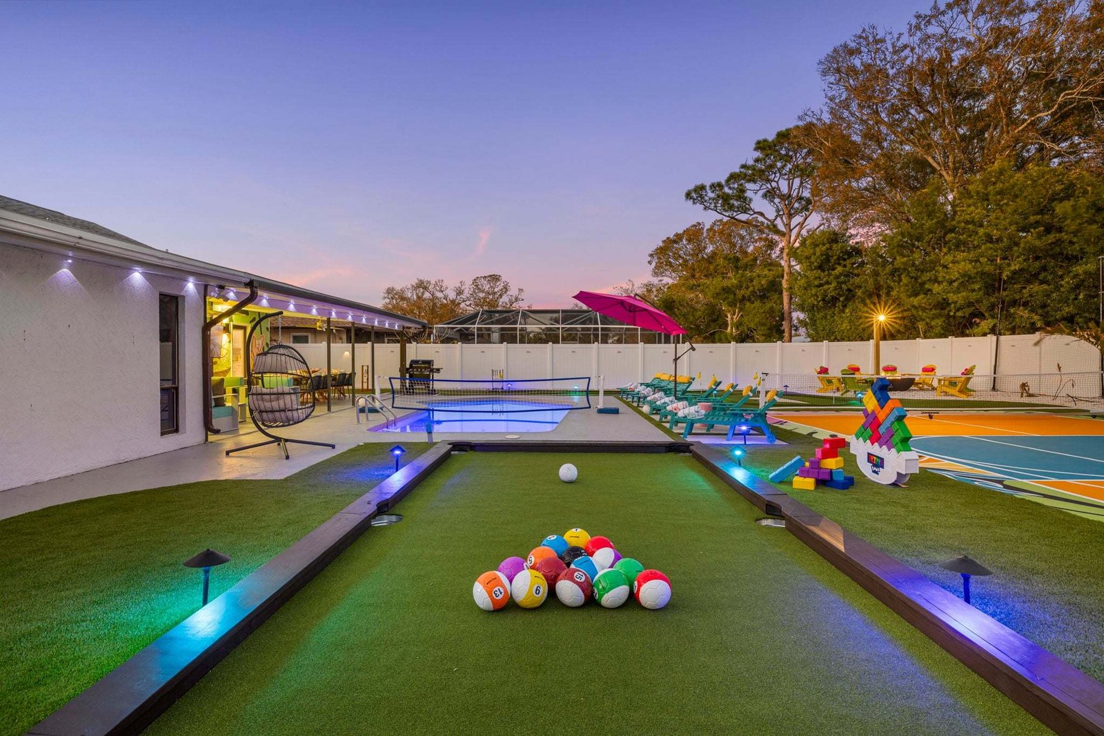 Turf billiards table with LED lights in a backyard game yard, installed by ProTurf Solutions